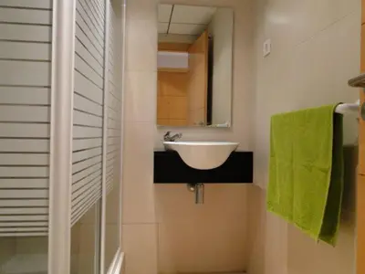 a bathroom with a sink and a mirror at Apartamentos Sitges in Sitges
