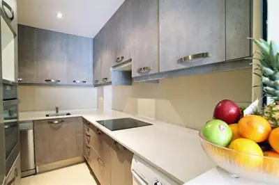 a kitchen with a bowl of fruit on the counter at Apartamentos Sitges in Sitges