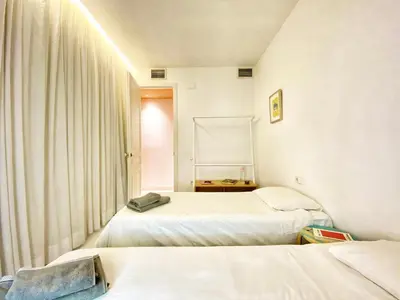 a room with two beds and a window at Tyche apartment in Barcelona