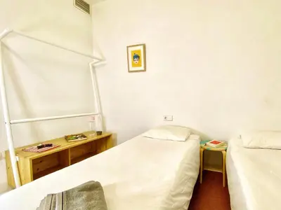 a hospital room with two beds and a table at Tyche apartment in Barcelona