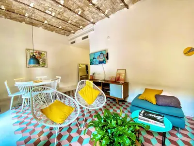 a living room with chairs and a couch and a table at Tyche apartment in Barcelona