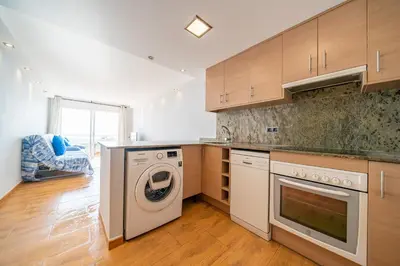 a kitchen with a washing machine and a dishwasher at HomeHolidaysRentals Marella - Costa Barcelona in Pineda de Mar