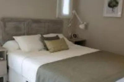 a bedroom with a white bed with two pillows at Lovely Sea view Apartment in Gava in Gavà