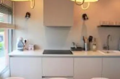 a kitchen with white cabinets and a counter top at Lovely Sea view Apartment in Gava in Gavà