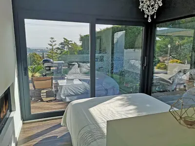 a bedroom with a bed and a large window at Premium Habitat La Plana in Argentona