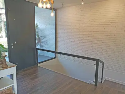 a room with a brick wall and a stair case at Premium Habitat La Plana in Argentona