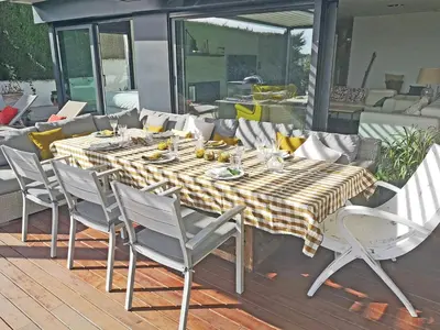 a dining table and chairs on a deck with a table and chairsktop at Premium Habitat La Plana in Argentona