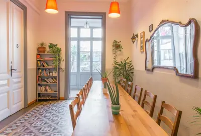 a dining room with a long table and chairs at Soul Backpackers Barcelona in Barcelona