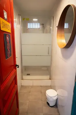 a bathroom with a shower with a toilet and a mirror at Soul Backpackers Barcelona in Barcelona