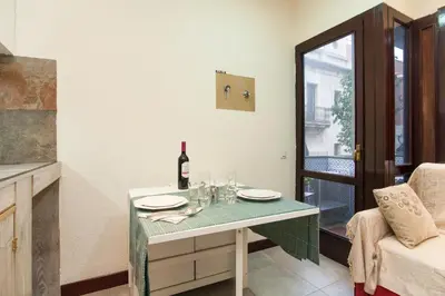 a dining room with a table with a bottle of wine at Flat Barcelona in Barcelona
