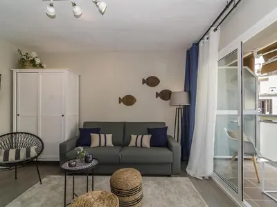 a living room with a couch and a table at Sitges Spaces Deluxe Centre Apartment in Sitges