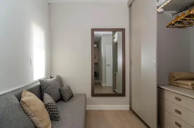a living room with a couch and a mirror at Sitges Spaces Deluxe Centre Apartment in Sitges