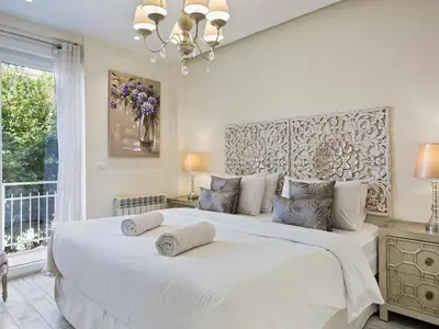 a bedroom with a large white bed with two pillows on it at Sitges Spaces Mediterranean Apartments 4 Bedroom in Sitges