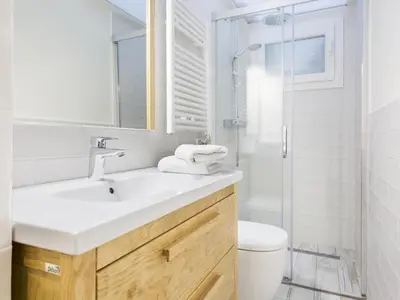 a bathroom with a sink and a toilet and a shower at Sitges Spaces Mediterranean Apartments 4 Bedroom in Sitges