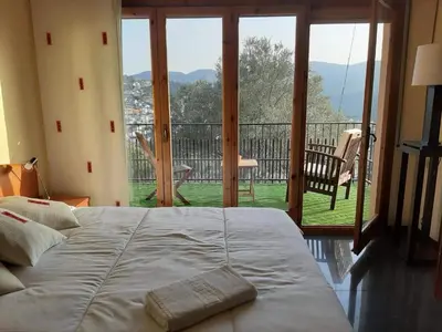 a bedroom with a bed and a view of a balcony at Habitaciones en Villa Coliving Casa Rural in San Fausto de Campcentellas