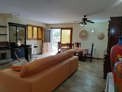 a living room with a couch and a dining room at Habitaciones en Villa Coliving Casa Rural in San Fausto de Campcentellas