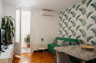 a living room with a green couch and a table at Nice Apartment in Barcelona