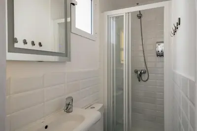 a white bathroom with a sink and a shower at Nice Apartment in Barcelona
