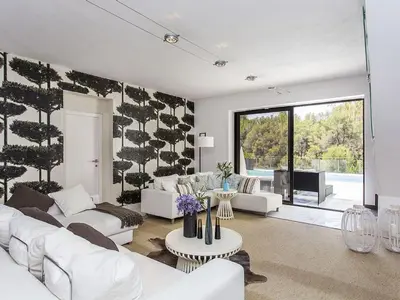 a living room with white furniture and a large window at Architect modern design villa in Sitges Hills in Olivella
