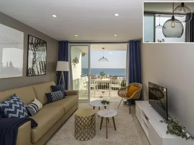 a living room with a couch and a view of the ocean at Sitges Spaces Sea View Paradise- 2 Bedrooms, 2 Bathrooms, Terrace, Amazing Sea Views in Sitges