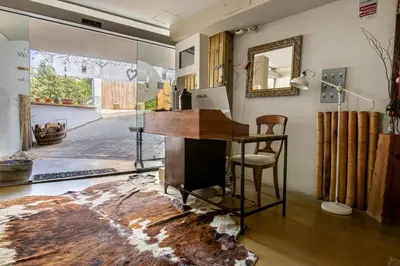 a room with a desk and a mirror at Les Suites in Santa María de Palautordera