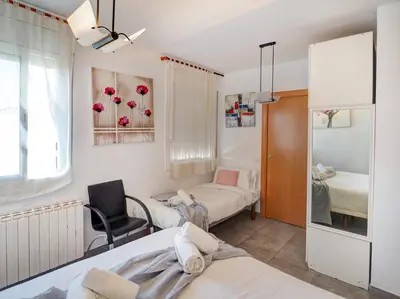 a hospital room with two beds and a chair at Linda Vista Oasis Penthouse by Hello Homes Sitges in Sitges