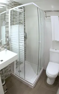 a bathroom with a shower and a toilet and a sink at Hotel BESTPRICE Diagonal in Barcelona
