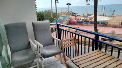 two chairs on a balcony with a view of the ocean at Beachfront Apartment with Sea Views & Private Parking in San Pol de Mar