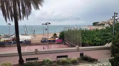 a view of a beach and the ocean from a building at Beachfront Apartment with Sea Views & Private Parking in San Pol de Mar