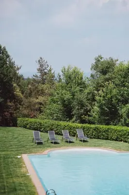 two lounge chairs sitting next to a swimming pool at La Caseta del Munt in Castelltersol
