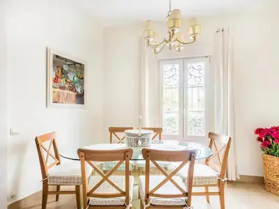 a dining room with a table and chairs and a chandelier at Sitges Spaces Beach House-4 bedrooms, 3 Bathrooms, Large Terrace, Jacuzzi, Center-Beach in Sitges