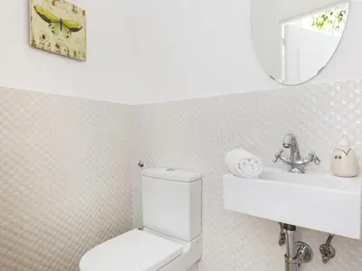 a bathroom with a toilet and a sink and a mirror at Sitges Spaces Beach House-4 bedrooms, 3 Bathrooms, Large Terrace, Jacuzzi, Center-Beach in Sitges