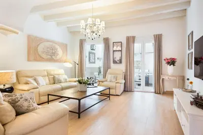 a living room with a couch and a table at Sitges Spaces Beach House-4 bedrooms, 3 Bathrooms, Large Terrace, Jacuzzi, Center-Beach in Sitges