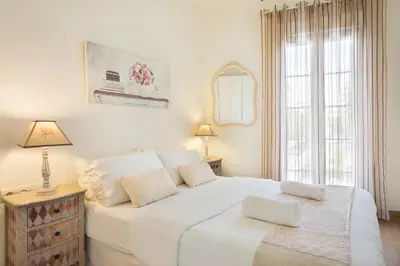 a white bedroom with a large bed and a window at Sitges Spaces Beach House-4 bedrooms, 3 Bathrooms, Large Terrace, Jacuzzi, Center-Beach in Sitges