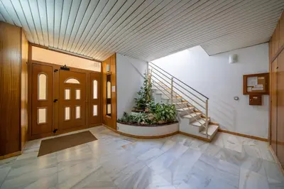 a hallway with a staircase and a door with a plant at HomeHolidaysRentals Destan - Costa Barcelona in Pineda de Mar