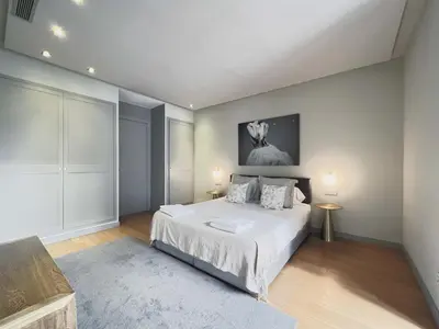 a bedroom with a large bed and a painting on the wall at Stay U-nique Apartments Rambla Catalunya II in Barcelona
