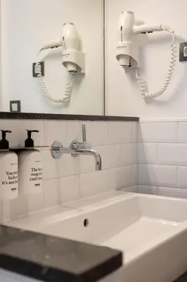 a bathroom with a sink and two phones on the wall at Colectia Stays Pau Claris in Barcelona