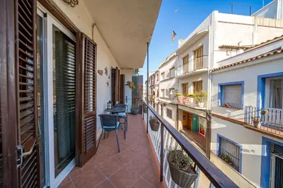 an apartment balcony with chairs and tables on it at HomeHolidaysRentals Plume - Costa Barcelona in Pineda de Mar