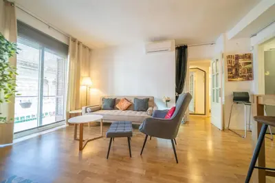 a living room with a couch and a table at HomeHolidaysRentals Plume - Costa Barcelona in Pineda de Mar
