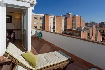 a balcony with a bench on top of a building at Gaudi penthouse with terrace views in Barcelona