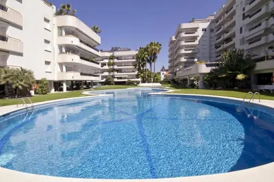 a large swimming pool in front of some apartment buildings at SITGES POOL & SEA TERRACE Luxury, comfort, unbeatable location in Sitges