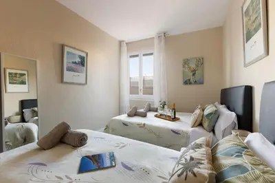a room with two beds and a window at Mercat Sant Antoni 1 in Barcelona