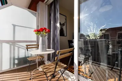 a balcony with a vase of flowers on a table at Mercat Sant Antoni 4 in Barcelona