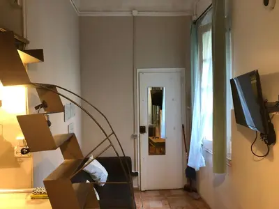 a living room with a lamp and a television at Estudio Finestrelles Barcelona in Esplugues de Llobregat