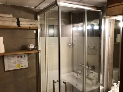 a glass shower in a bathroom with a sink at Estudio Finestrelles Barcelona in Esplugues de Llobregat