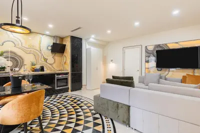 a living room with a white couch and a tv at Cosmo Apartments Rambla Catalunya in Barcelona
