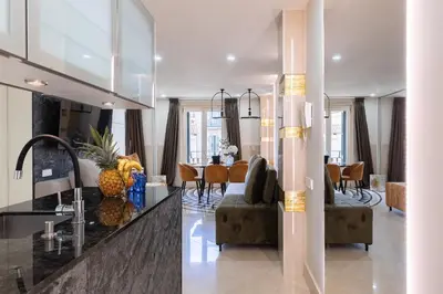 a kitchen and living room with a pineapple on the counter at Cosmo Apartments Rambla Catalunya in Barcelona