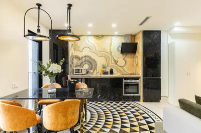a dining room with a black table and chairs at Cosmo Apartments Rambla Catalunya in Barcelona