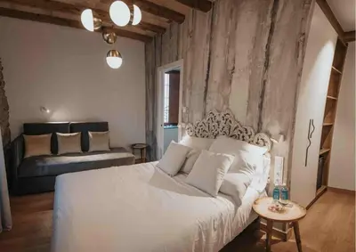a bedroom with a large white bed and a couch at Les Quingles in Calders