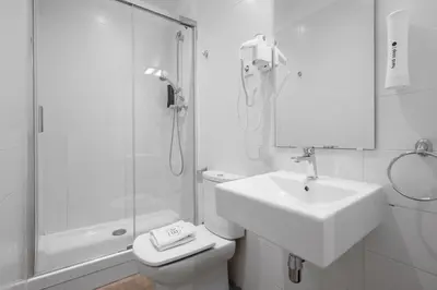 a bathroom with a toilet and a sink and a shower at AB Gran de Gràcia in Barcelona